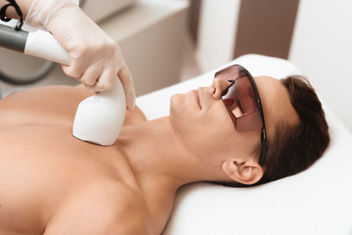 Man receiving laser hair removal treatments on his chest