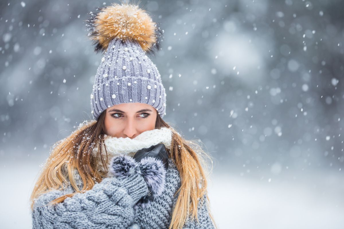 Woman bundled up in winter clothes in the snow